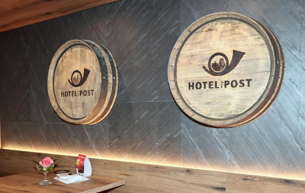 two wine barrels on the wall of a restaurant at Hotel zur Post 3 Sterne superior in Altenahr