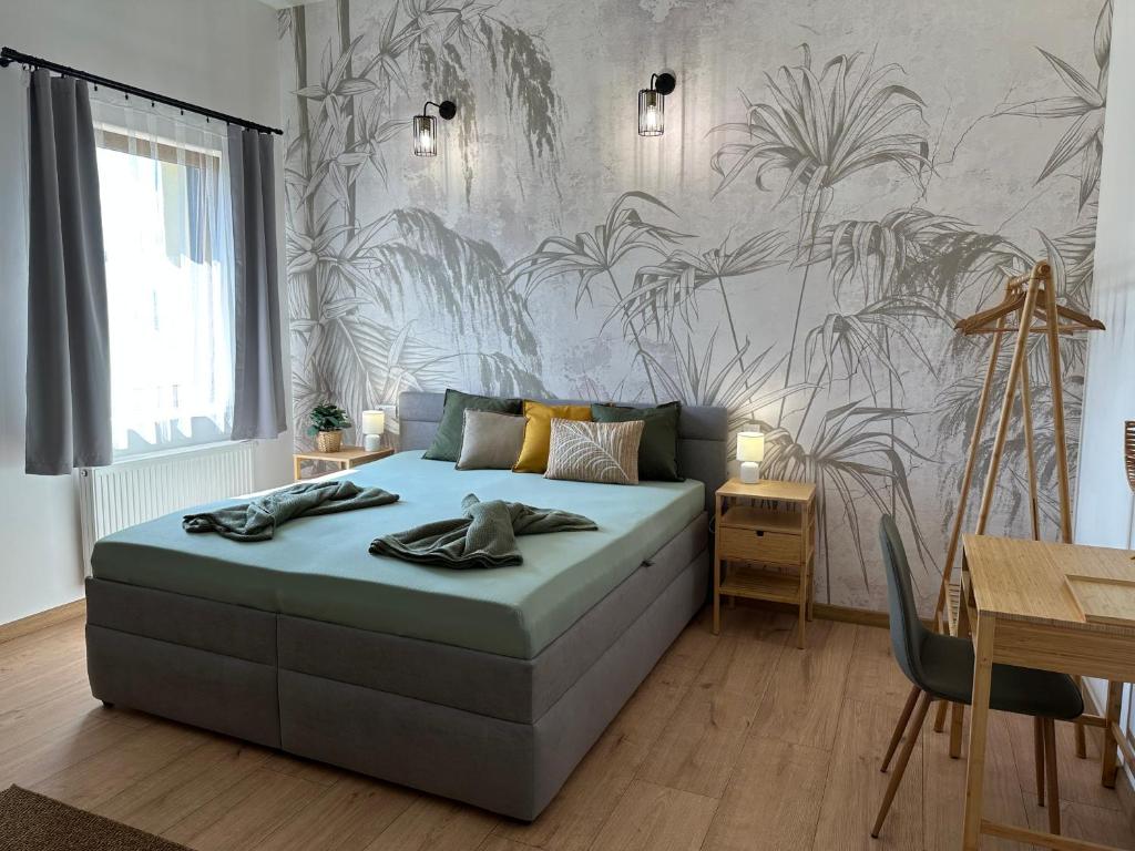 una camera con letto e parete con piante di GREEN Apartment – City Centre – Main Square a Liptovský Mikuláš