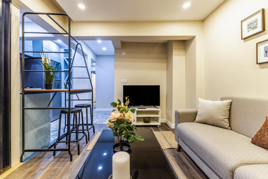 a living room with a spiral staircase and a television at Centrally Located Flat in Sisli İstanbul in Istanbul