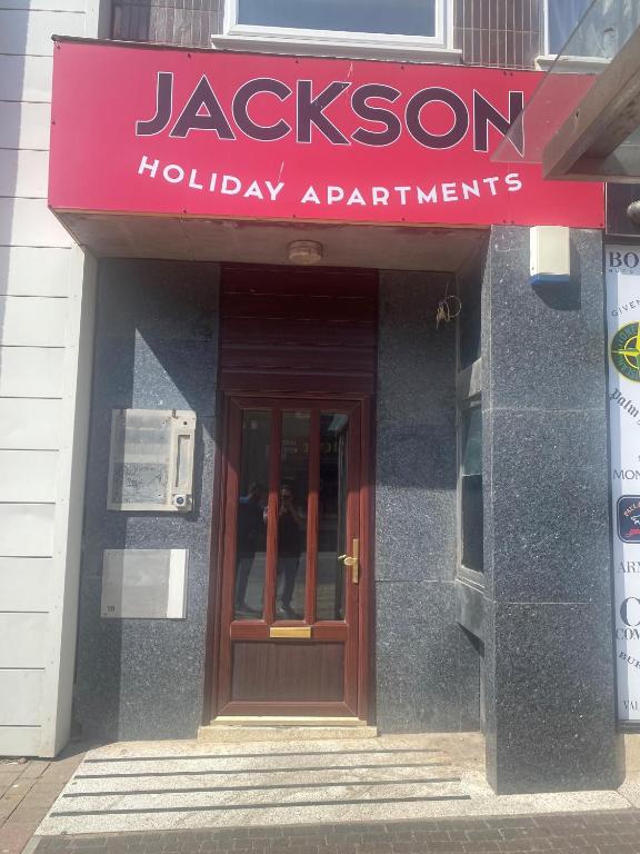 a building with a sign that reads jackson holiday apartments at Jackson Holiday Apartments in Blackpool