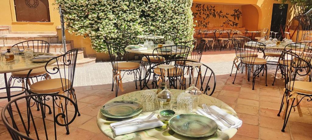 a restaurant with tables and chairs with plates on them at Hôtel La Pérouse Nice Baie des Anges in Nice