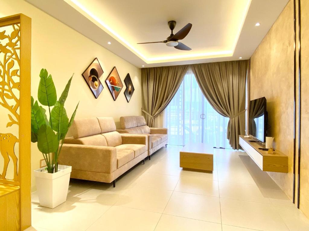 a living room with a couch and a tv at Armadale Residence 3R3B GalaCity Airport in Kuching