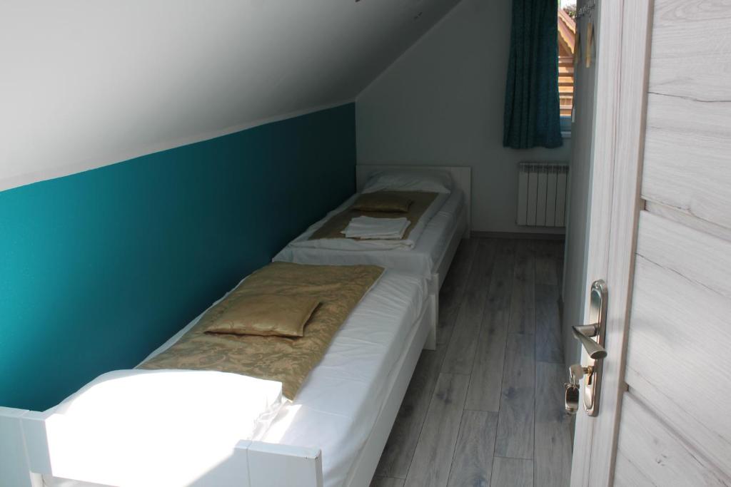 Postel nebo postele na pokoji v ubytování Jaworina- Apartamenty, Domki i Pokoje