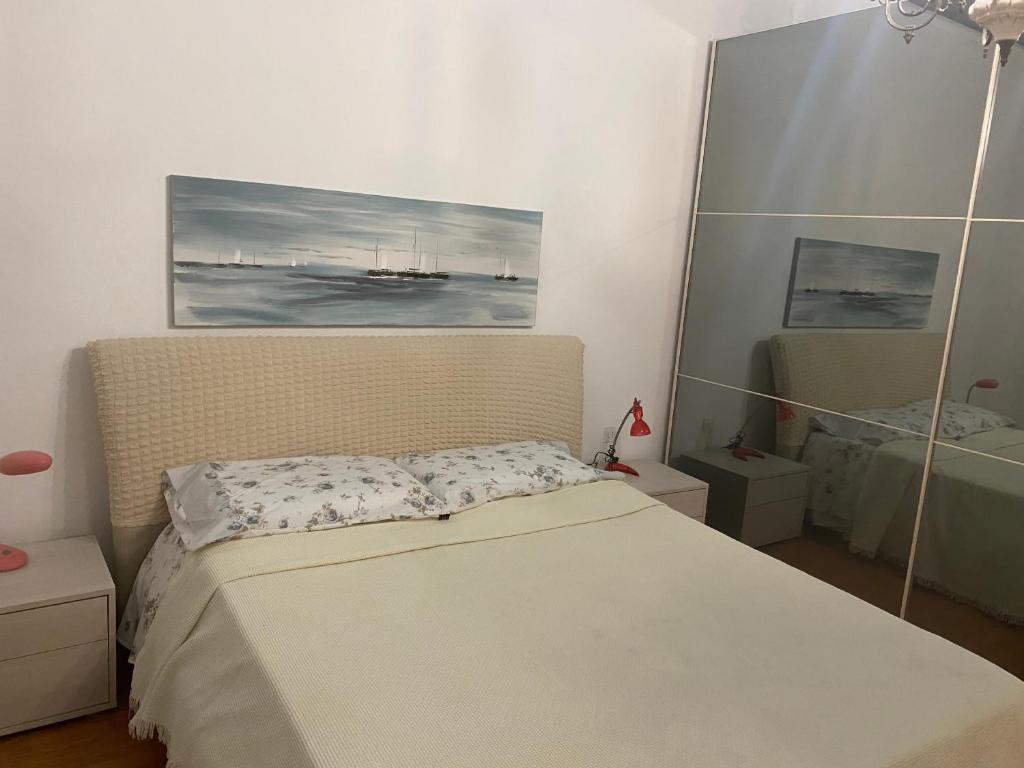 a bedroom with a bed and a painting on the wall at Sunny house in SantʼAmbrogio di Valpolicella