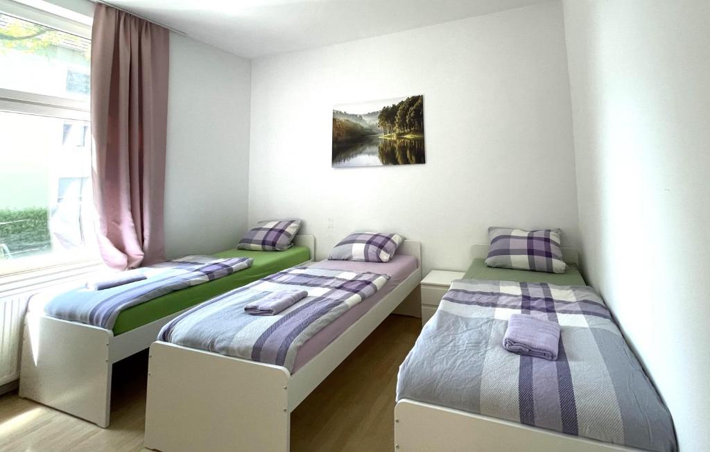 a room with two beds and a window at Gelsenkirchen, 2-Zimmer Wohnung , 6 Person in Gelsenkirchen