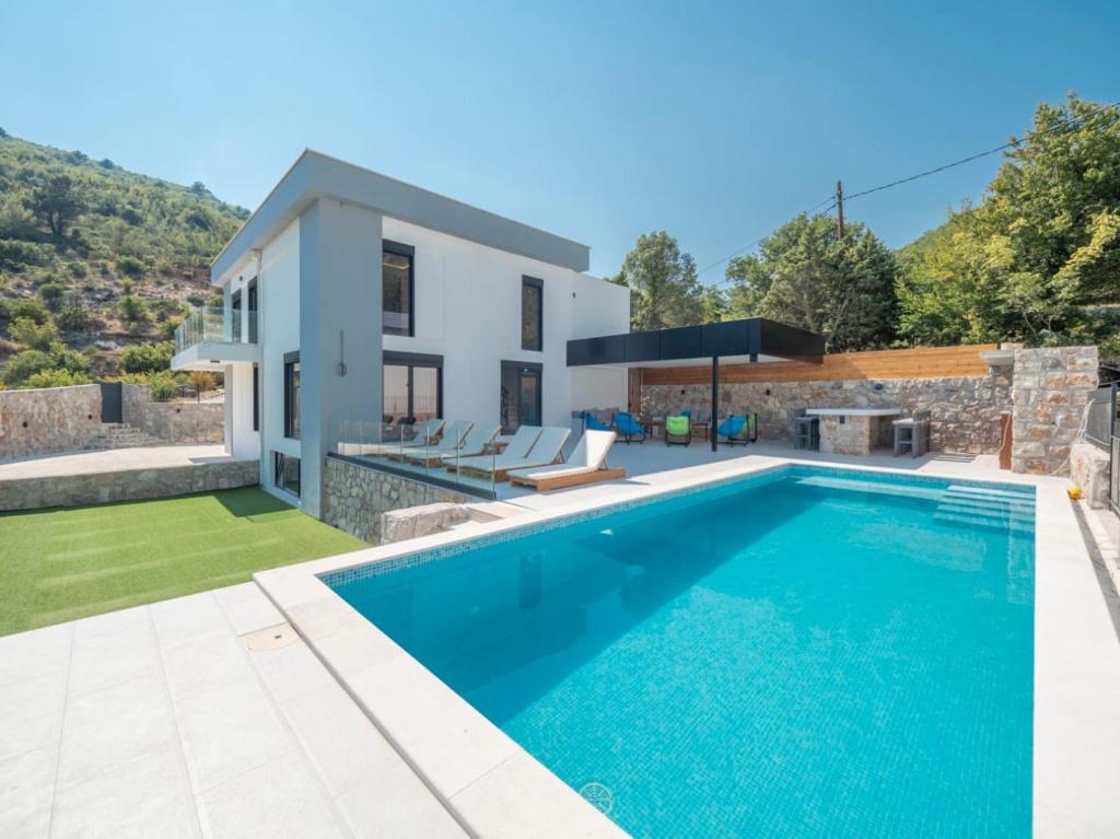 a villa with a swimming pool and a house at Seaview Villa with pool-Vanja in Budva