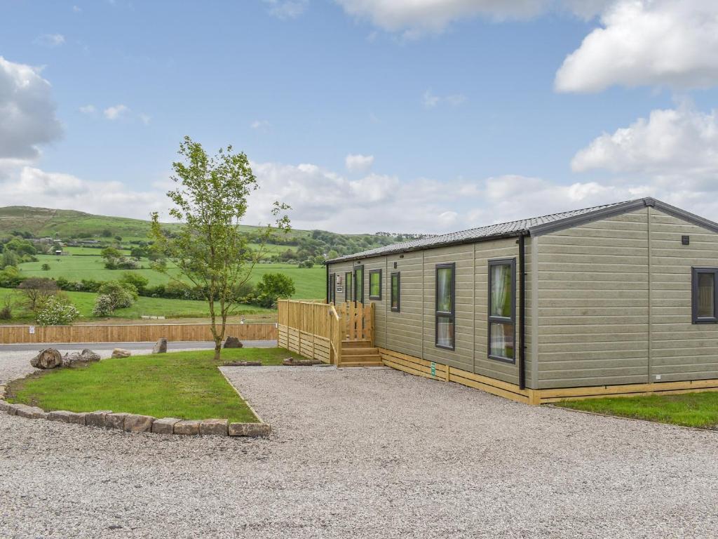 a tiny house on a gravel lot with a fence at Lake View - Uk36811 in Whalley