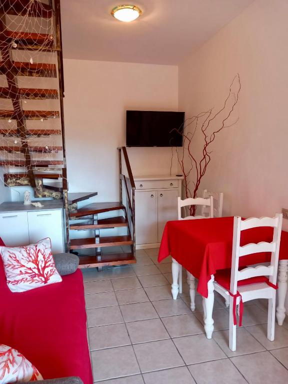 a living room with a table and a television at I Coralli in Villasimius