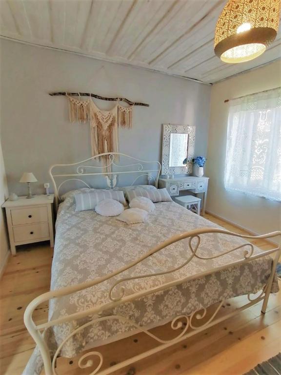 a bedroom with a large bed in a room at Maria's traditional house in Trikeri