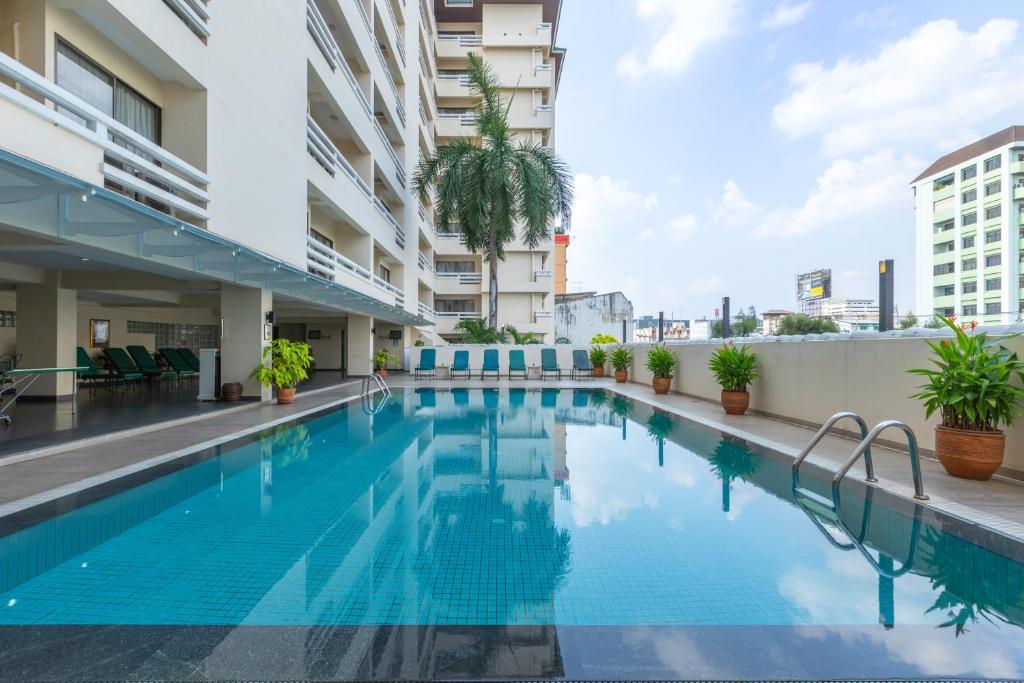 a swimming pool in the middle of a building at Kantary House Hotel, Bangkok in Bangkok