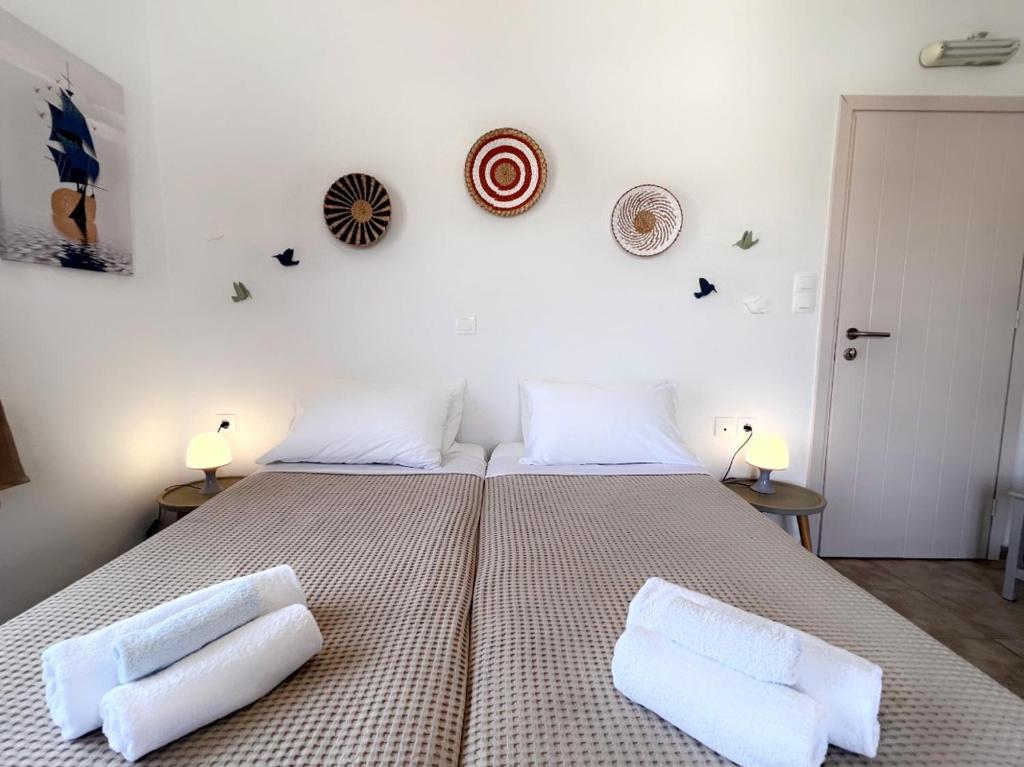 a bedroom with a large bed with two pillows on it at Anna Studios in Katapola