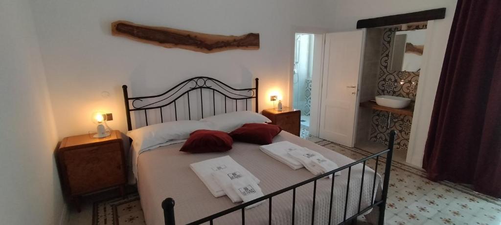 a bedroom with a large bed with towels on it at Le Scale di Pietra in Conversano