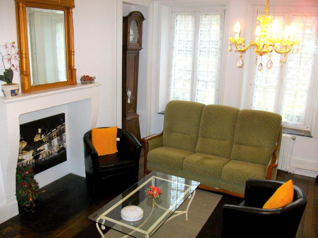a living room with a couch and a fireplace at Les rosieres 