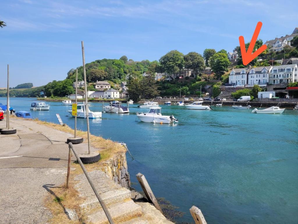a group of boats are docked in a harbor at Looe Spacious 4 Double bedroom House Sleeps 9 Harbour River Views in Looe