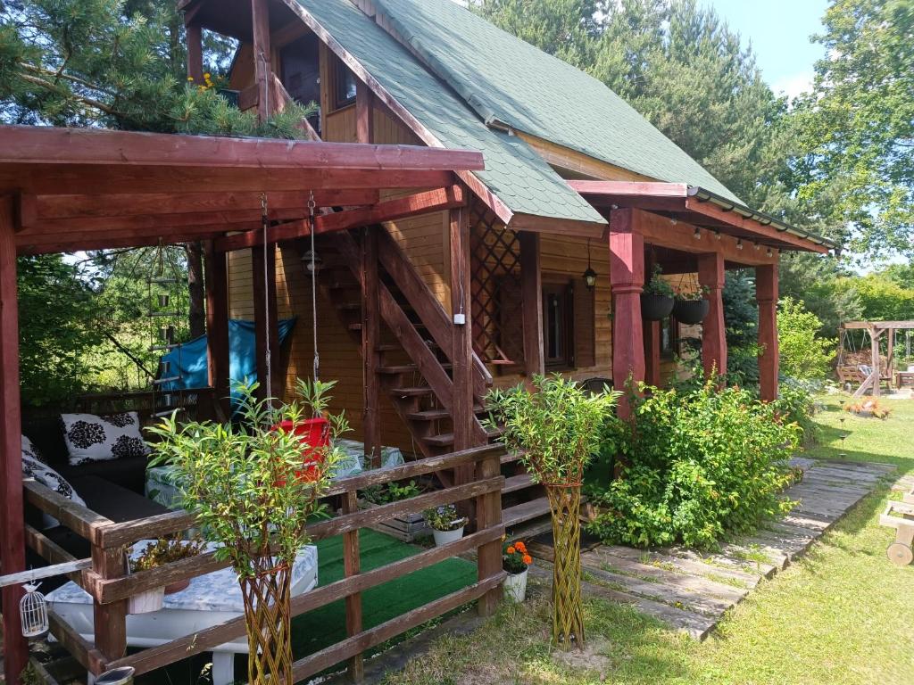 a log cabin with a staircase leading up to it at Domek drewniany Wiakówka in Kazimierz Dolny