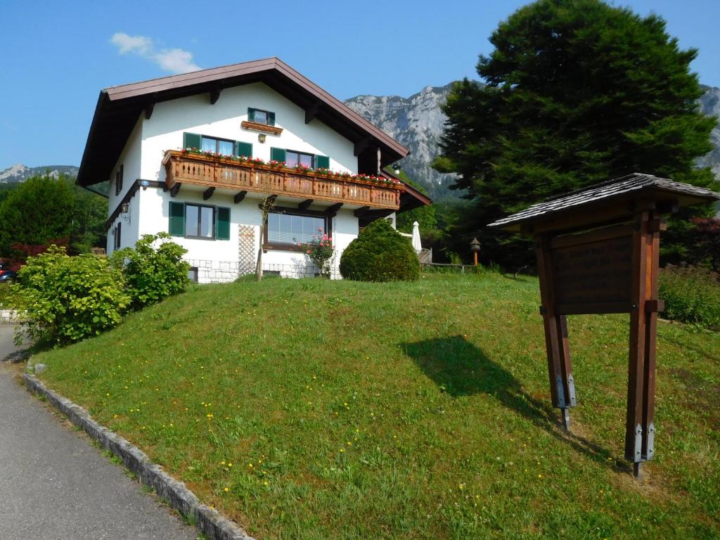 a house on a hill with a sign in front of it at Haus Bader in Steinbach am Attersee