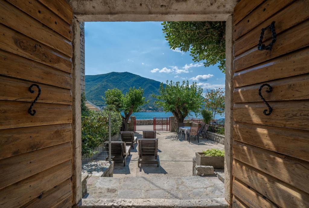 an open door to a patio with a view of the water at Regina di Dobrota in Kotor