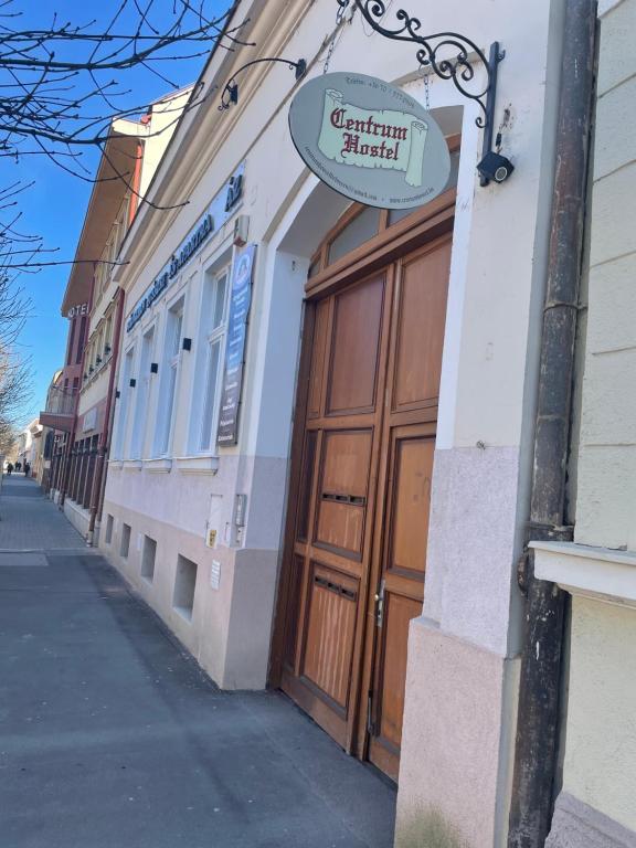 um sinal na lateral de um edifício com uma porta em Centrum Wellness Hostel em Debrecen