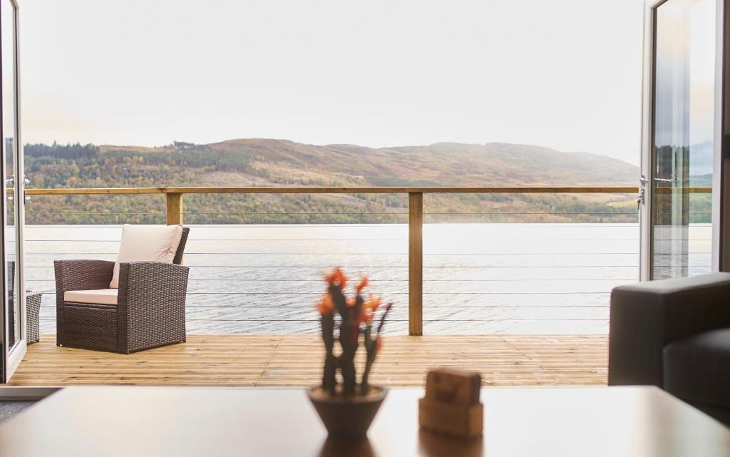 a living room with a view of the water at Shoreland Lodges - Cherry Lodge in Fort Augustus