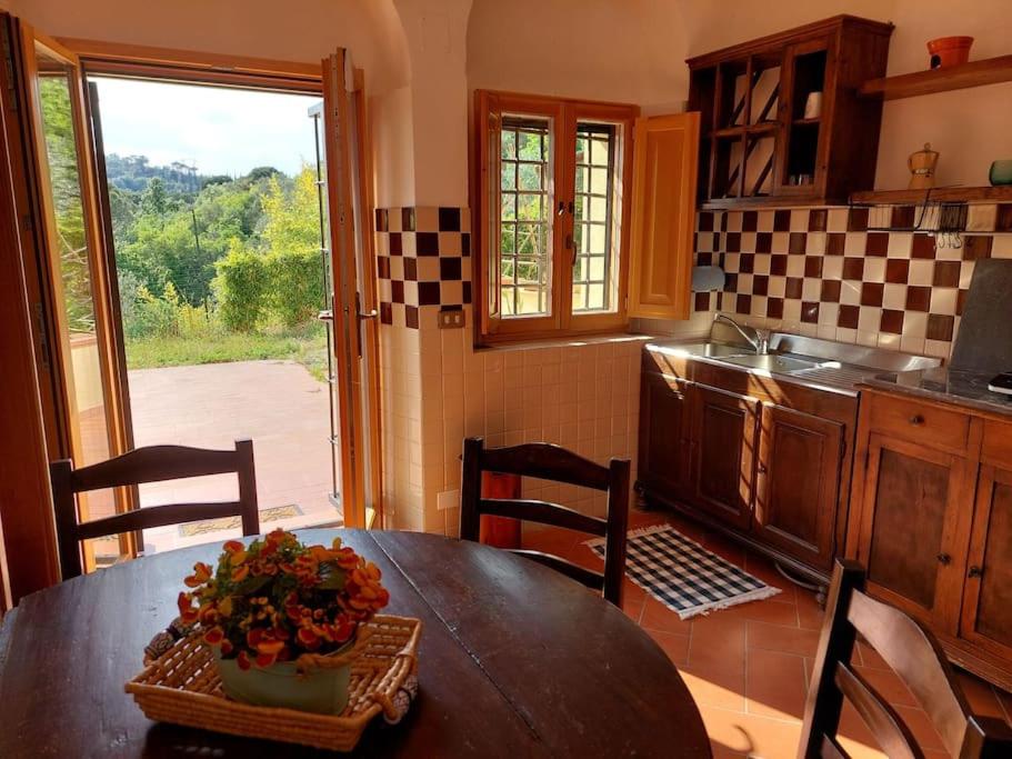 a kitchen with a table with a bowl of flowers on it at Dependance nel Chianti a pochi minuti da Firenze in Impruneta