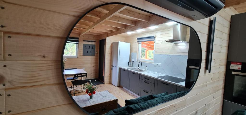 a kitchen and dining room in a tiny house at Piniowy Domek - Roztocze in Siedliska