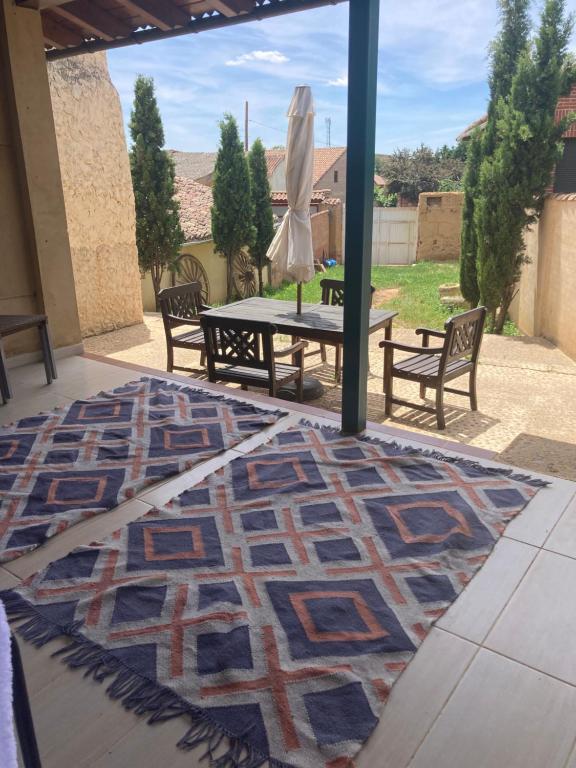 a patio rug with a table and chairs on a patio at El encanto de un pueblo 