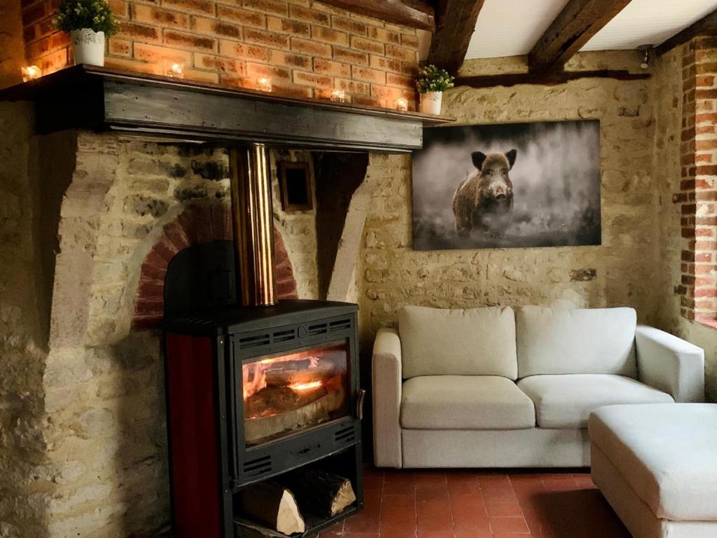 a living room with a couch and a fireplace at La ferte 