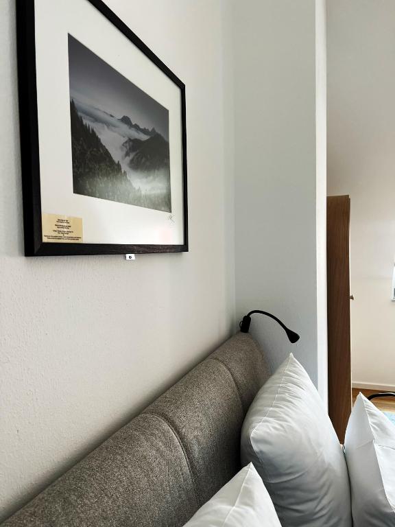 a living room with a couch and a picture on the wall at Hotel Prinz in Munich