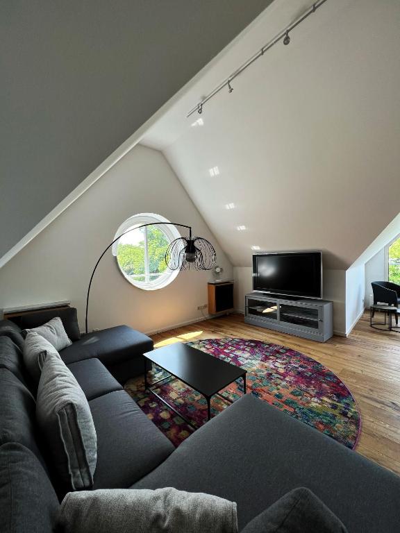 a living room with a couch and a table at Hotel Prinz in Munich