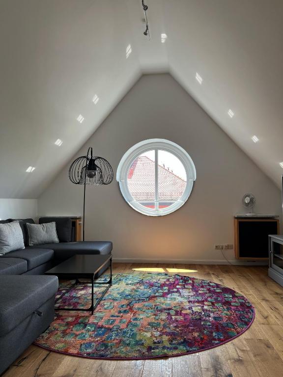 a living room with a couch and a window at Hotel Prinz in Munich