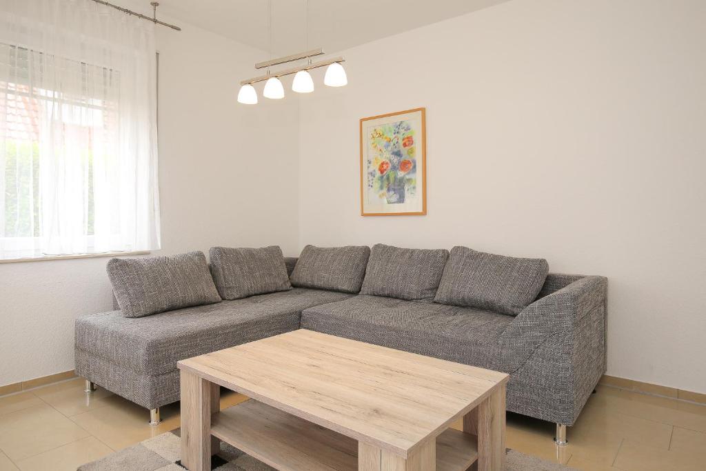 a living room with a couch and a table at Sanddornweg Wohnung 13 a in Boltenhagen