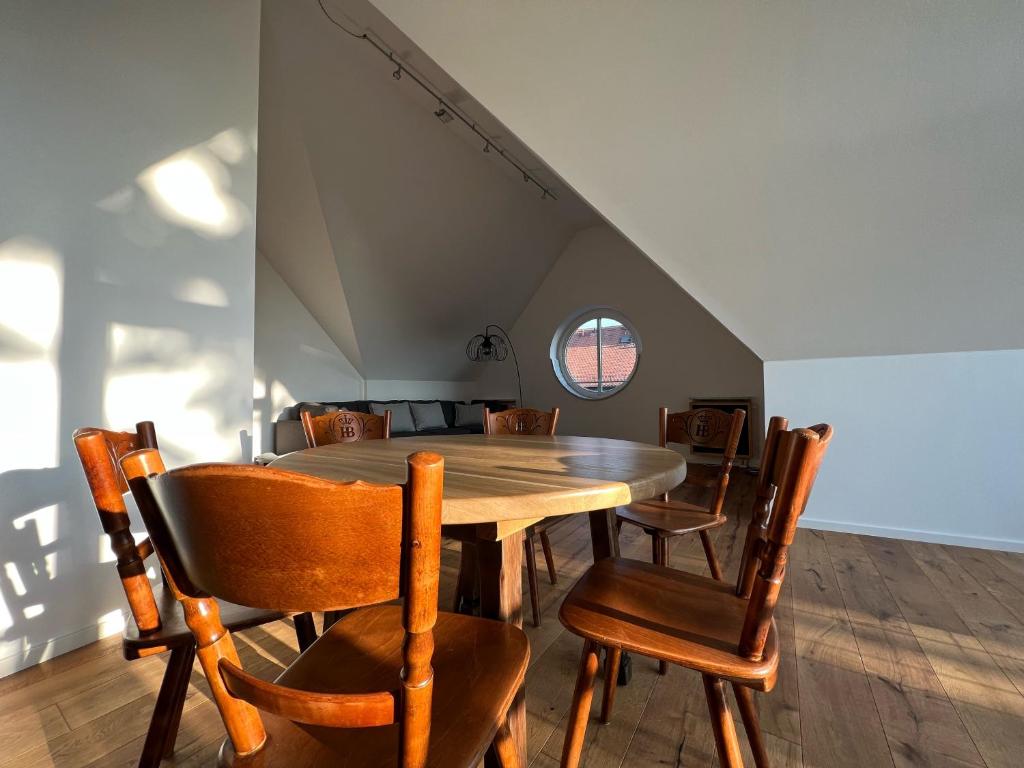 a dining room with a wooden table and chairs at Hotel Prinz in Munich