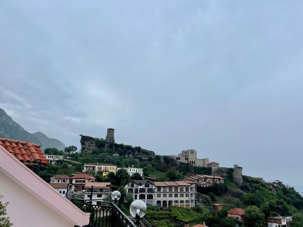 a town on a hill with houses on it at DEAL Castle View Rooms in Krujë