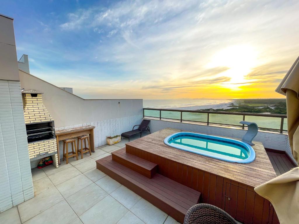 a balcony with a hot tub on top of a building at Cobertura Luxo Sophia I - Orla Praia Grande in Arraial do Cabo
