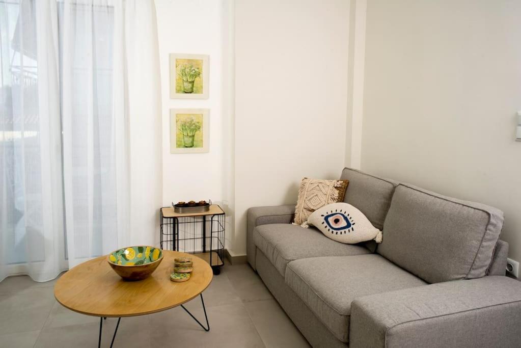 a living room with a couch and a table at G&K House View in Messini