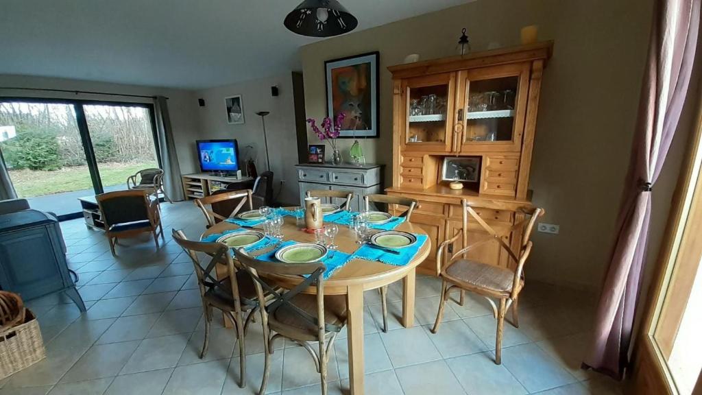 eine Küche und ein Esszimmer mit einem Tisch und Stühlen in der Unterkunft L'appel de la foret in Rocroi