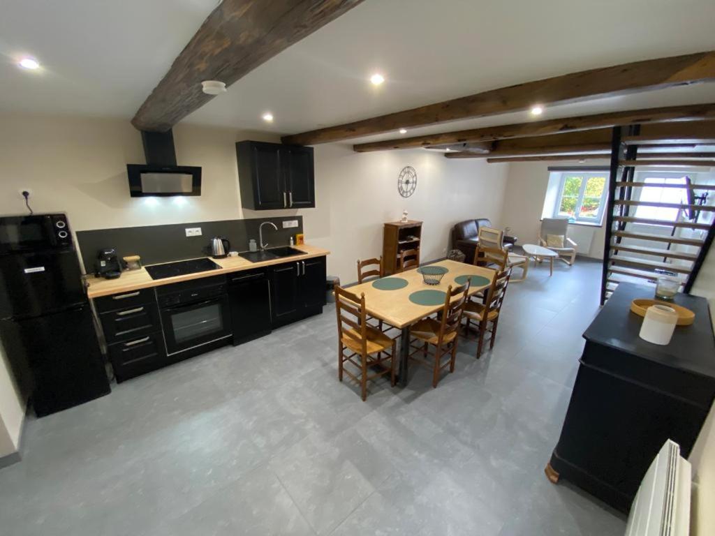 a kitchen and dining room with a table and chairs at Gite de la semoy in Haulmé