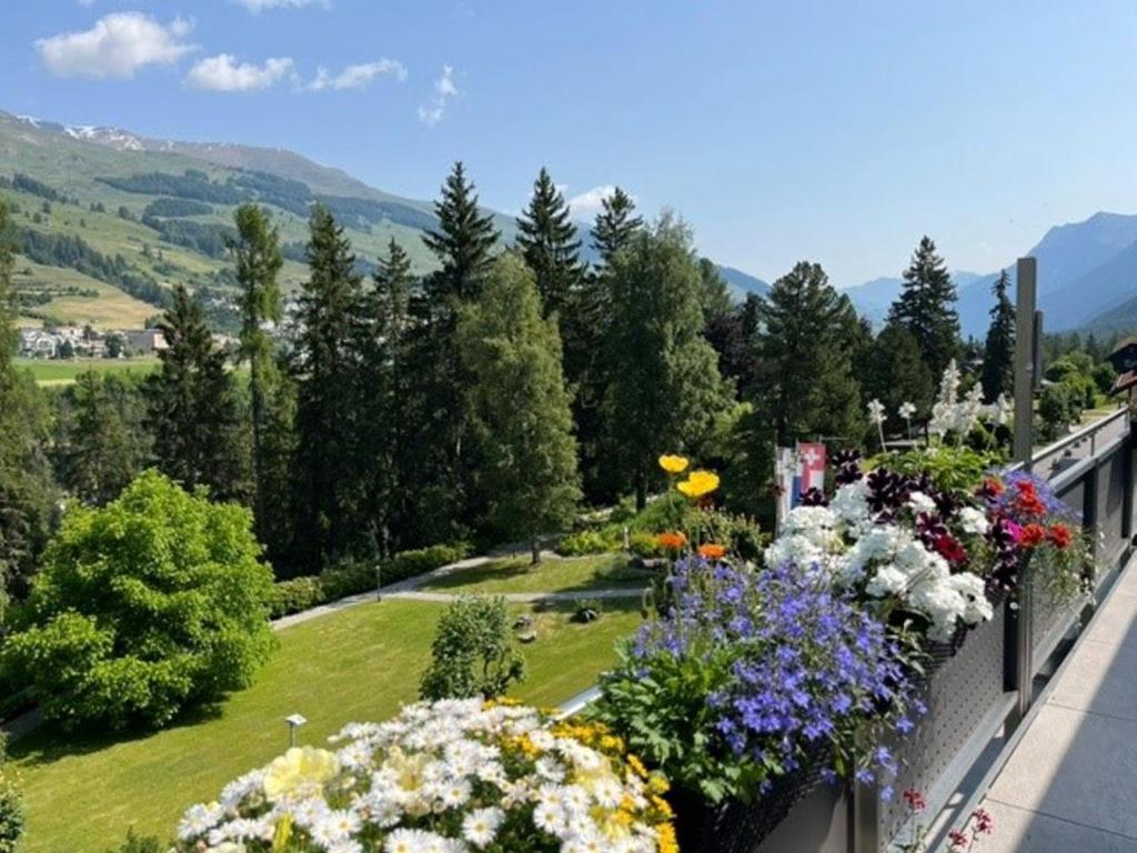 a balcony filled with lots of flowers at Chasa Plavna 403 in Vulpera