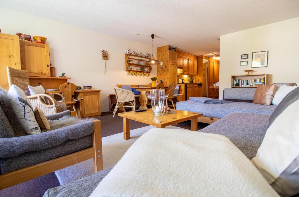 a living room with couches and a table at Rothornblick 19 in Arosa