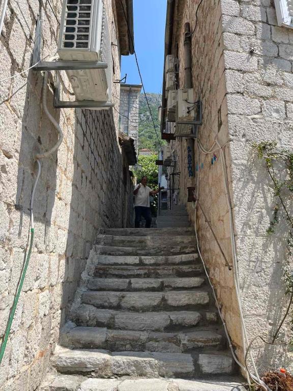 an alley with stairs in an old stone building at Apartman Dado in Perast