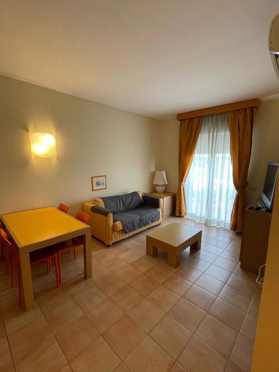 a living room with a couch and a table at Tristan casa vacanze a Roma in Casal Palocco