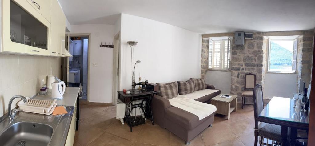 a living room with a couch and a sink at Apartman Dado in Perast