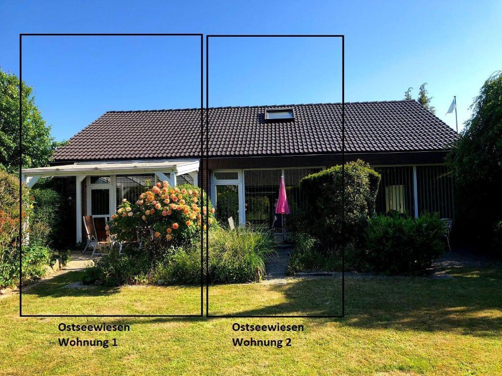 a house with a large mirror in front of it at Ostseewiesen-1 in Hohwacht