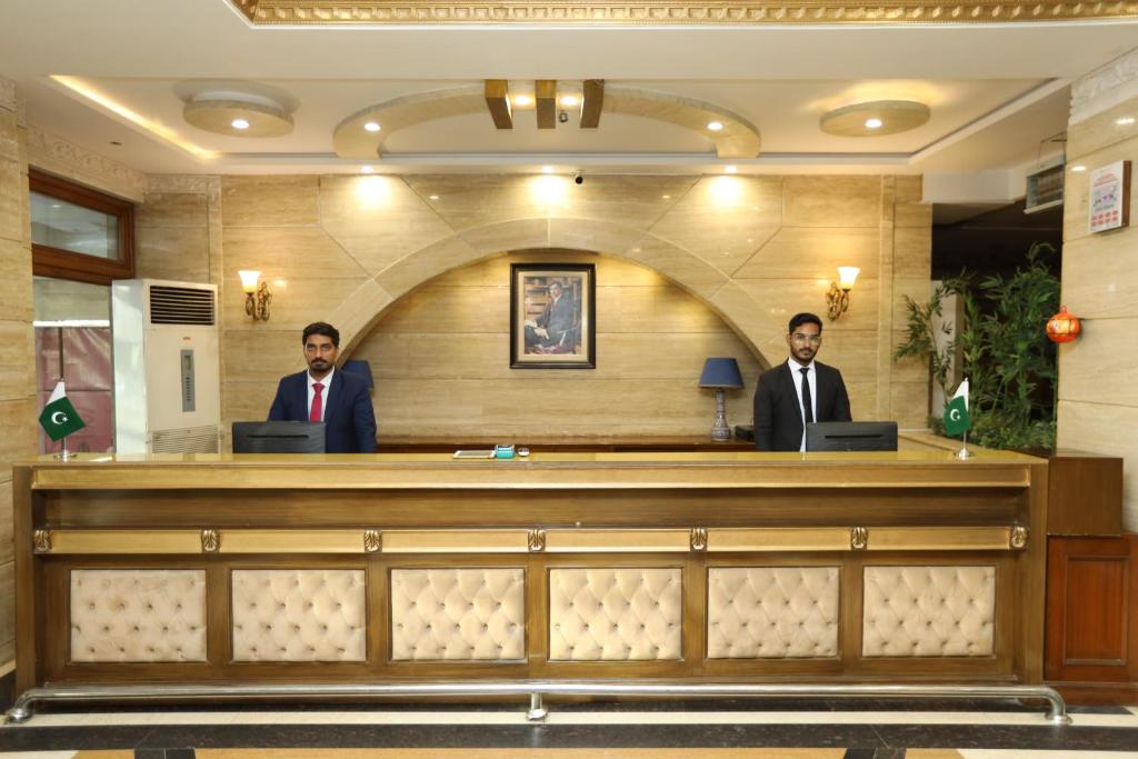 two men in suits sitting at a court bench at Magnum Swiss Inn in Lahore