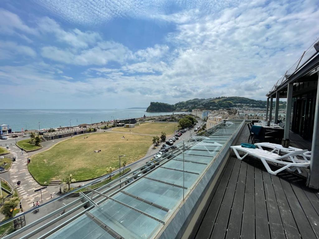 a balcony of a building with a view of the ocean at Riviera Apartments - Five Stylish Penthouse Apartments with Unrivalled Sea Views of Teignmouth, Shaldon, The Jurassic Coastline & The Teign Estuary in Teignmouth