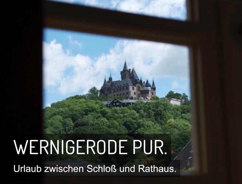 a window view of a castle on top of a hill at Ferienwohnung direkt Am kleinsten Haus in Wernigerode in Wernigerode