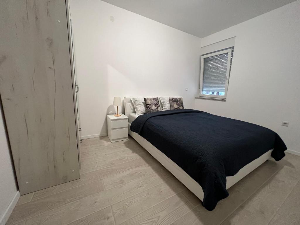 Rúm í herbergi á Apartman Panonica