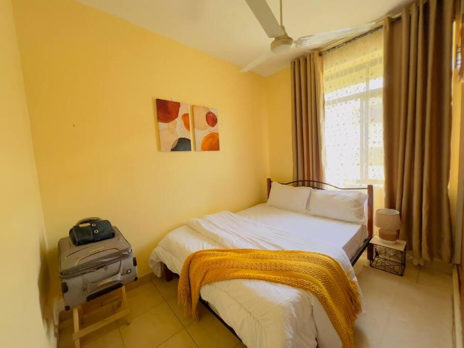 City Loft Arusha tesisinde bir odada yatak veya yataklar