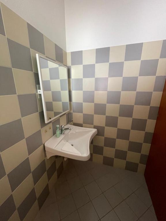 a bathroom with a sink and a mirror at Lunga Via Delle Dolomiti in Calalzo