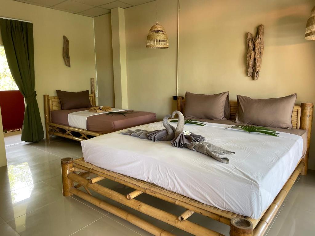 Postel nebo postele na pokoji v ubytování Mythai Guesthouse